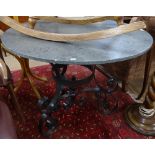 A circular slate-top conservatory/garden table, on a scrolled wrought-iron base, W100cm