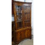 A large mahogany concave corner display cabinet, with 4 doors, on bracket feet, W92cm, H188cm