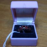 A gold and 9-stone set garnet band ring
