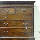 An early 19th century mahogany chest on chest, with carved pediment and fluted canted corners, width