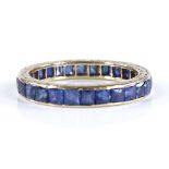 An unmarked gold square-cut sapphire eternity ring, with engraved bridge, band width 3mm, size M,