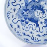 A Chinese blue and white porcelain charger, with painted dragon decoration, 4 character mark,