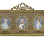 A 19th century French empire gilt-brass frame, containing 3 miniature watercolour portraits on