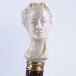 An early 20th century rosewood parasol handle, with carved ivory woman's head finial