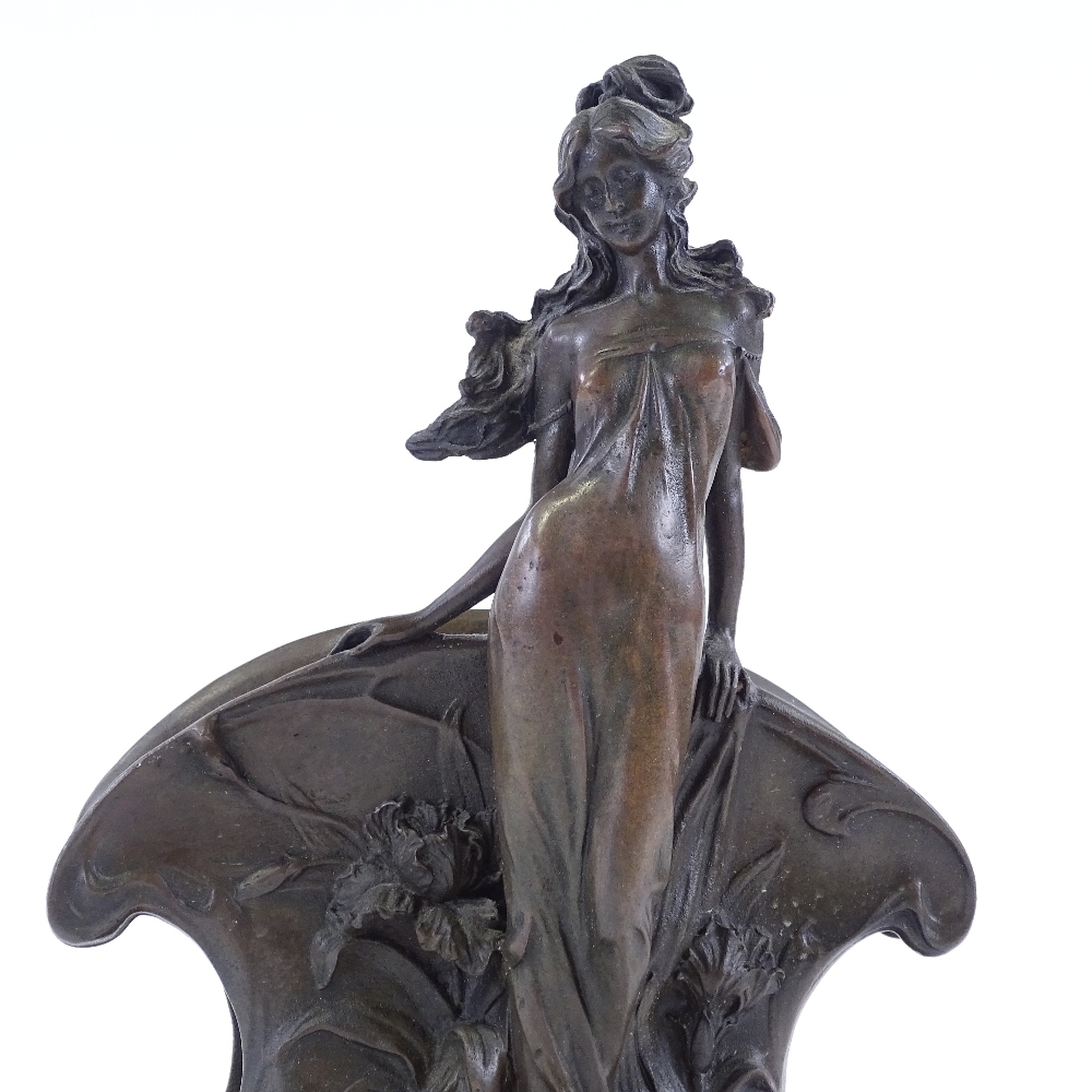 A reproduction bronze letter rack, after Claude Mirval, in the form of standing woman, on black