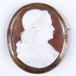 An Antique relief carved cameo brooch, depicting Pope Leo XIII, in unmarked gold Greek key design