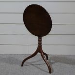 A 19th century circular mahogany tilt-top wine table on tripod base, 19.5" across