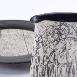 Louise Darby (British - born 1957), a Studio pottery jug and charger, black glaze with incised and
