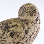 A large mid-20th century ceramic owl with textured sgraffito decoration, unsigned, on stained wood