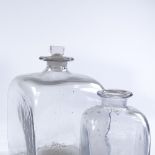 A large handmade square glass bottle, width 14cm, and a smaller bottler, early 19th century (2)