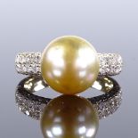 A 14ct gold whole cultured South Sea pearl dress ring, with diamond set shoulders, pearl diameter