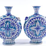 A pair of Indian blue glaze pottery moon-shaped vases, height 25cm