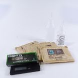 A Caliber Digital hygrometer and thermometer, and 2 humidification solution bottles, with 6 bags