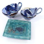 Jacqueline Norris, Studio pottery Coptic fish design dish, width 18cm, and 4 Studio pottery mugs