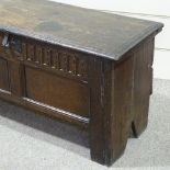 A 17th/18th century joined oak coffer, with carved and panelled front, width 110cm