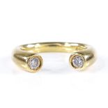 An 18ct gold 2-stone diamond ring, each end of ring set with a diamond, total diamond content approx