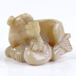 A Chinese carved white jade reclining dragon netsuke, length 3.5cm