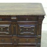 A Jacobean joined oak chest of 4 long drawers, with fielded moulded drawer fronts, and walnut or
