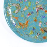 A Chinese blue glaze porcelain charger, with painted enamel butterflies and flowers, 6 character