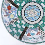 A large Japanese porcelain charger with painted enamel decoration, diameter 45cm