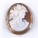 A Victorian relief carved cameo brooch, depicting Classical female bust, in engraved gilt-metal