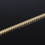 A 14ct gold diamond tennis line bracelet, each diamond approx 0.075ct, total diamond content