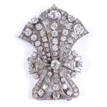 An Art Deco unmarked platinum and diamond plume fan brooch, set with triangular, baguette and