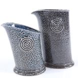 Walter Keeler (British - born 1942), 2 salt-glaze leaning pouring jugs, blue/grey glaze, applied