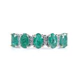 A 14ct white gold emerald and diamond half-hoop ring, total emerald content approx 1.24ct, total