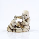 A Japanese Meiji period ivory netsuke, in the form of 2 crouching figures, height 4cm