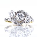An 18ct gold 3-stone diamond crossover ring, with platinum-topped settings, central stone approx 0.