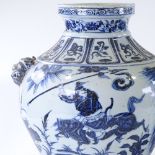 A large pair of Chinese blue and white porcelain jars, with relief dragon mask handles and painted