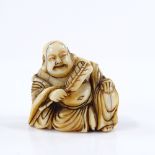 A Japanese 18th century ivory netsuke, in the form of a Hotei with a fan, height 3cm