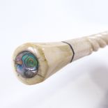 A 19th century marine ivory walking stick with spiral twist design, tapered octagonal ivory handle