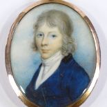 An early 19th century miniature watercolour on ivory, portrait of a young gentleman wearing a blue
