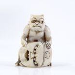 A Japanese Meiji period ivory netsuke, in the form of a demon and mask, height 4.5cm