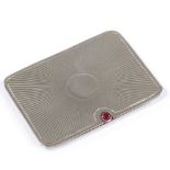 A rectangular silver double postage stamp case, with sliding action, cabochon garnet thumb piece,