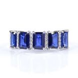 A 14ct white gold sapphire and diamond half-hoop ring, total emerald-cut sapphire content approx 2.