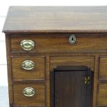 A George III mahogany kneehole writing desk of small size, with drawers and alcove cupboard, width