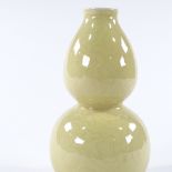 A Chinese yellow glaze porcelain double gourd vase, with incised floral designs, 4 character mark,