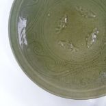 A Chinese celadon green glaze porcelain table centre bowl, with relief fish designs, diameter 38cm