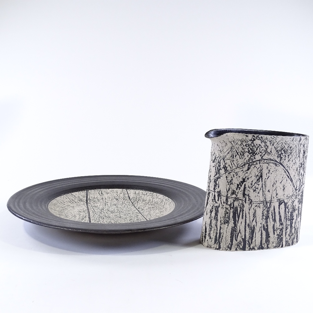 Louise Darby (British - born 1957), a Studio pottery jug and charger, black glaze with incised and - Image 2 of 5