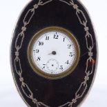An Edwardian tortoiseshell and silver-cased travelling clock, with enamel dial and stained wood