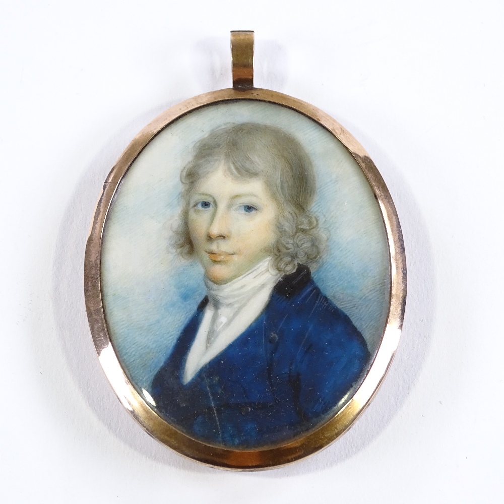 An early 19th century miniature watercolour on ivory, portrait of a young gentleman wearing a blue - Image 2 of 3