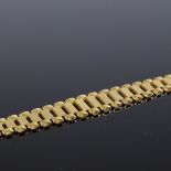 A 9ct gold spacer link graduated bracelet, with textured central panels, length 19cm, 12.9g