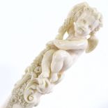 A 19th century finely carved ivory page turner, the handle decorated with a seated cherub and