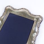 A large modern silver-fronted photo frame, with foliate floral border, by Carr's of Sheffield,