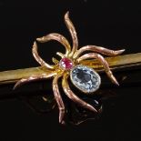 A 9ct gold figural spider bar brooch, set with oval-cut aquamarine abdomen and ruby carapace, brooch