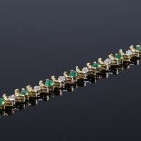 A 10ct gold emerald and diamond tennis line bracelet, length 19cm, 12.3g