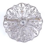 An Art Deco platinum and diamond circular brooch, with pierced leaf design, brooch diameter 31.